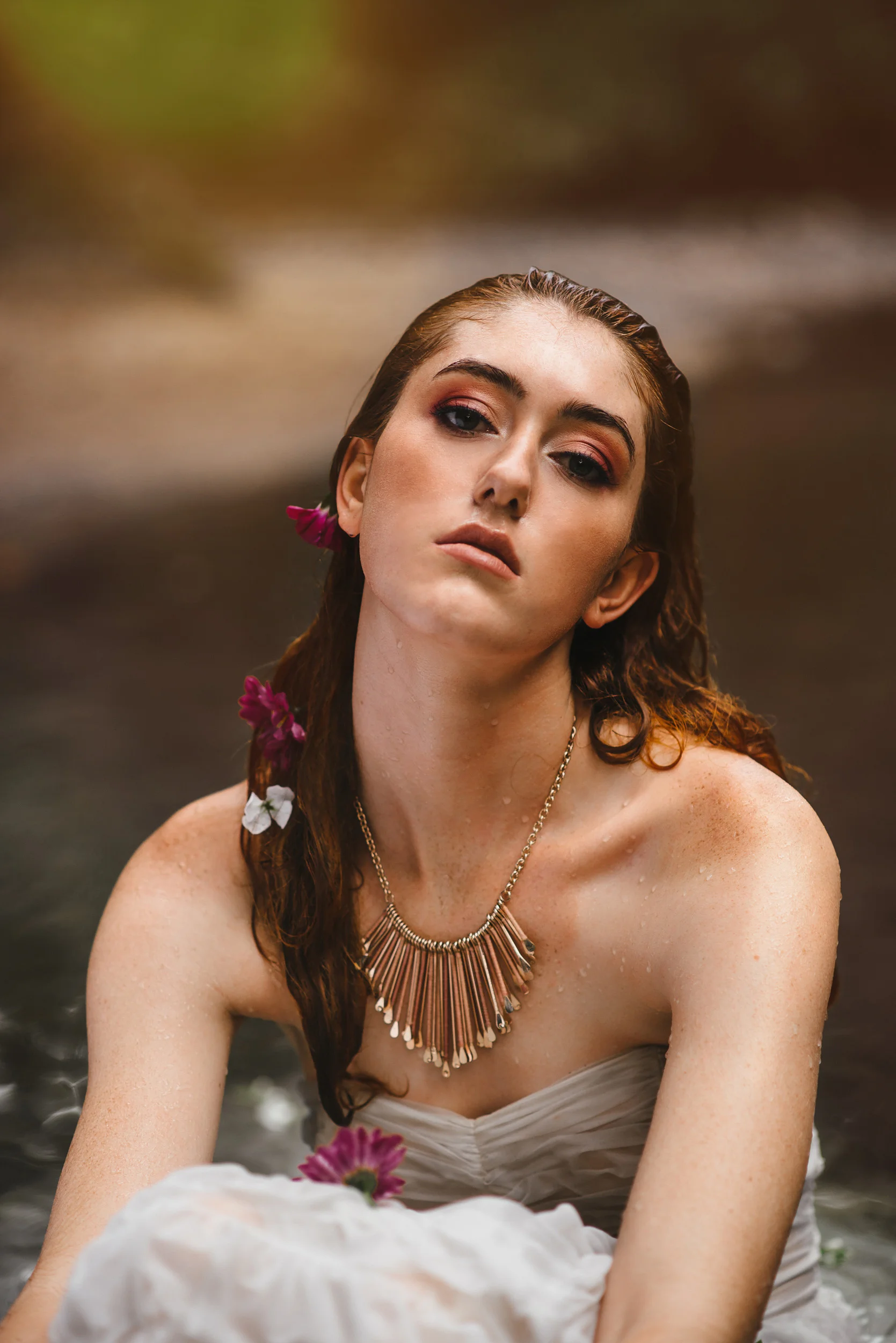 White vintage dress in the water with flowers by Sarah Hooker Photography
