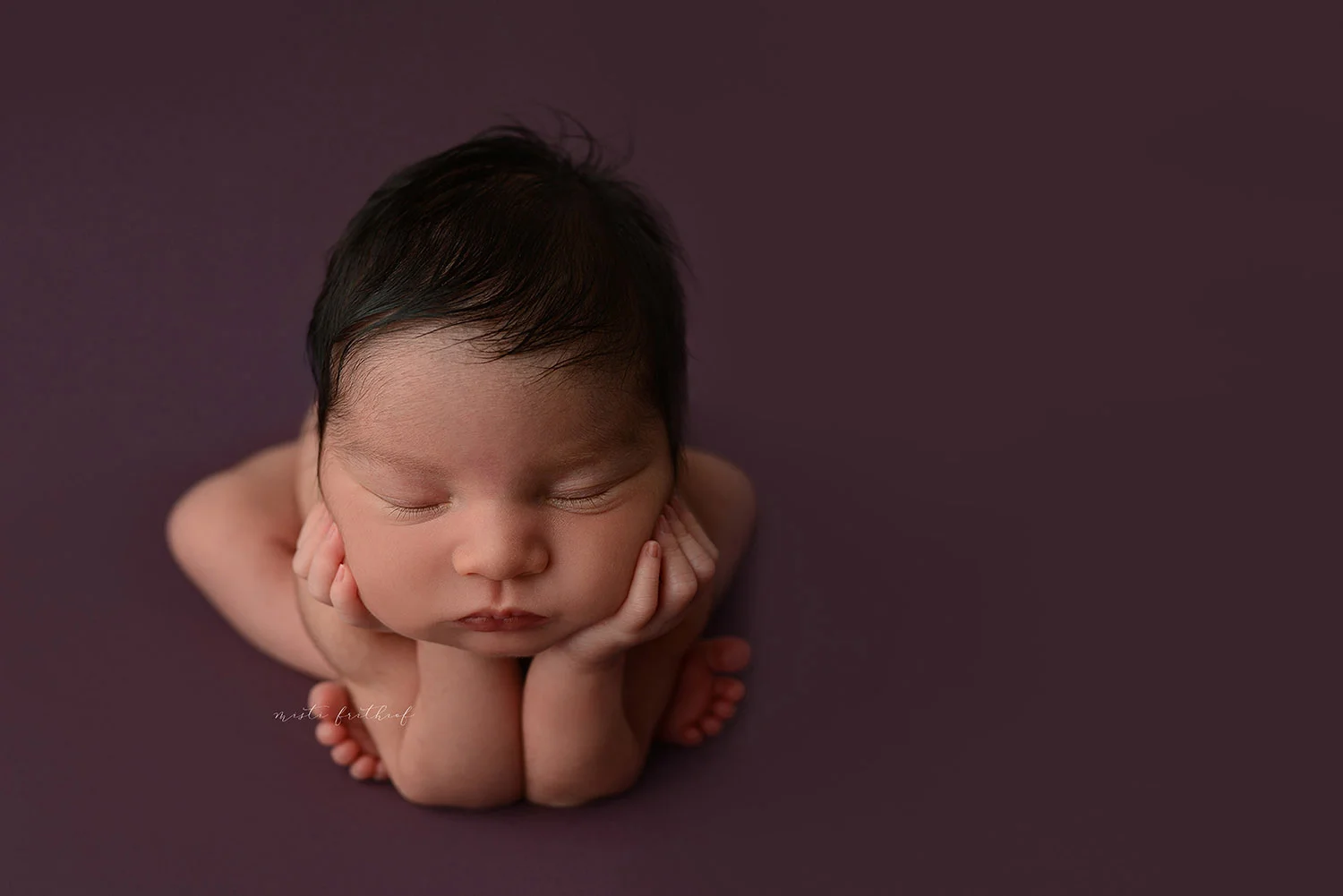 Newborn baby girl in the frog pose fast asleep at my studio Misti Frithiof Photography. 
