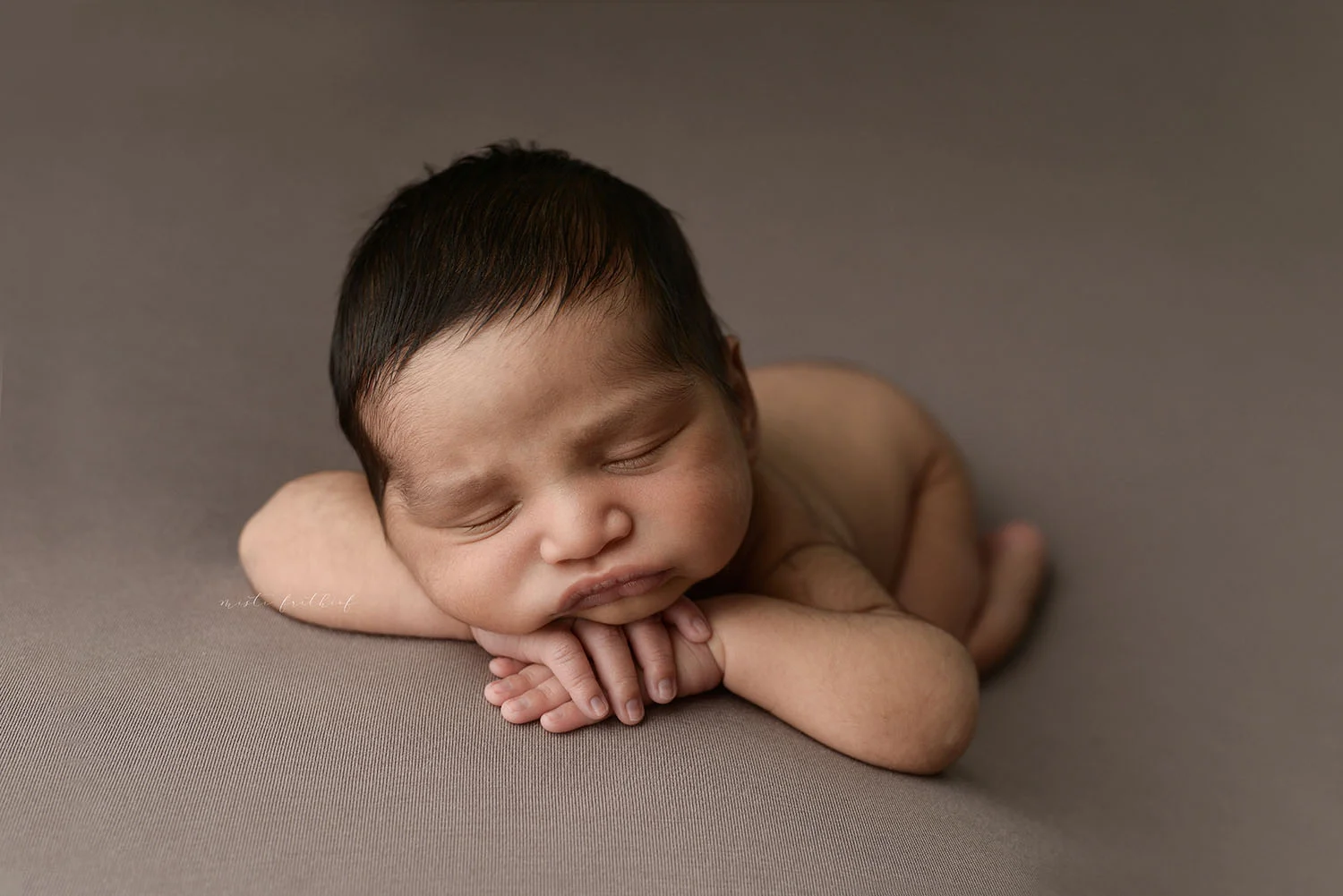 Handsome baby boy sleeping during his newborn photography session at Misti Frithiof Photography in Austin, Texas.