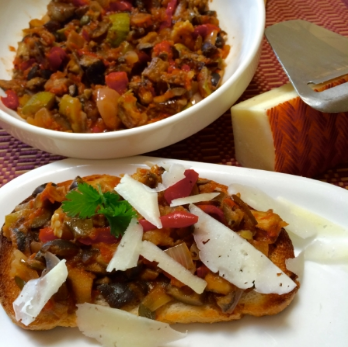 Making ahead has its advantages: it allows the flavors to blend for better taste AND it makes for an easy lunch: here, I toasted a few slices of bread, topped them with cooled down caponata, and shaved some Manchego cheese on top. Priceless!