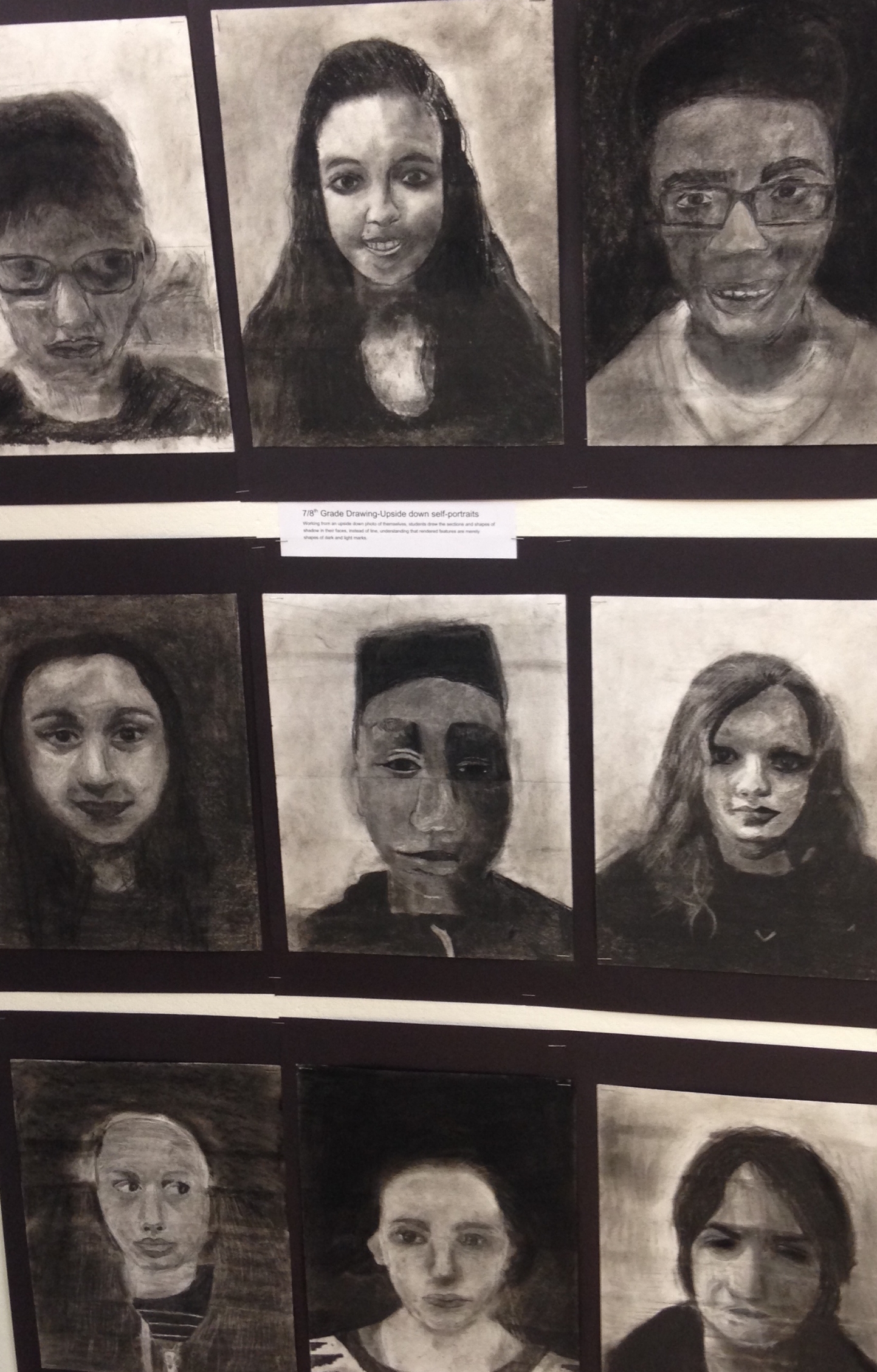 7th and 8th Grade Upside-Down Self-Portraits in Charcoal