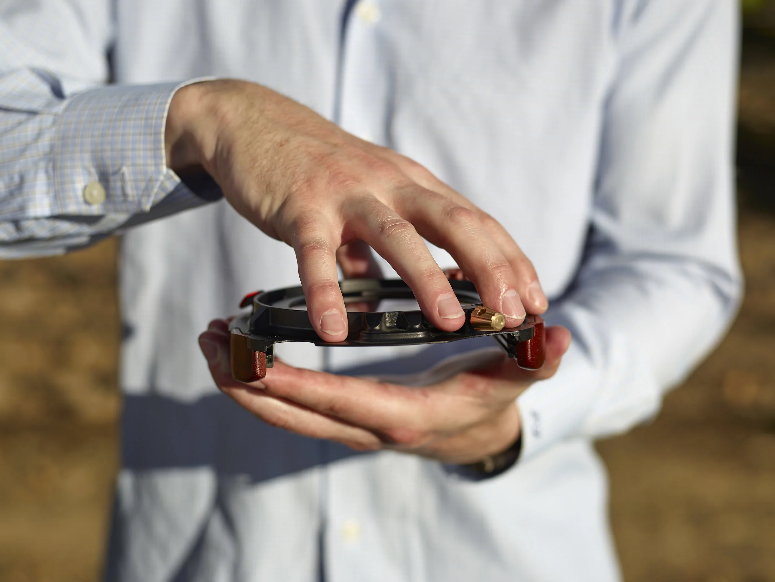 Position your hand to catch the polarizer, then invert the system.