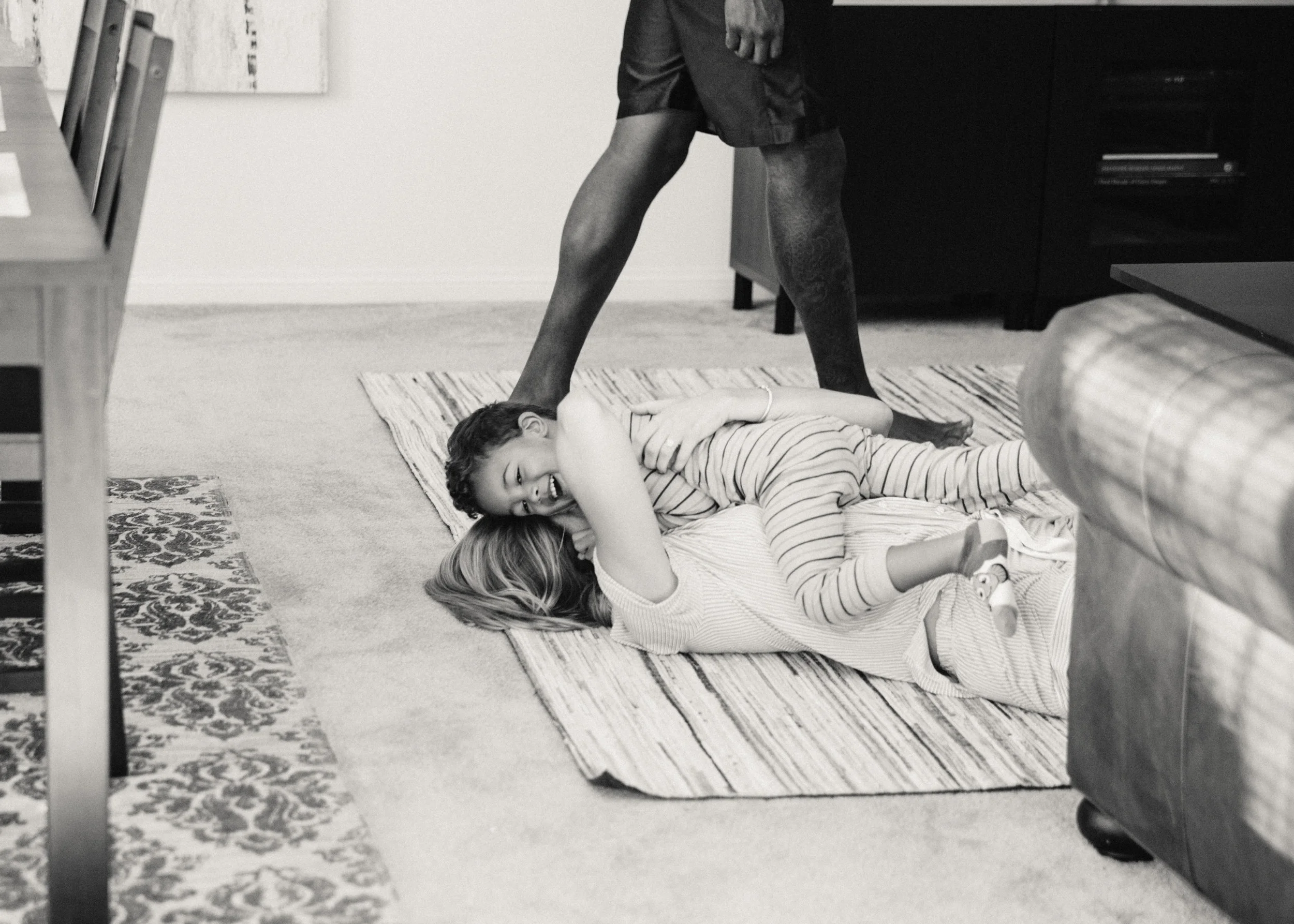Bree and Carson on the floor as Dad walks by 