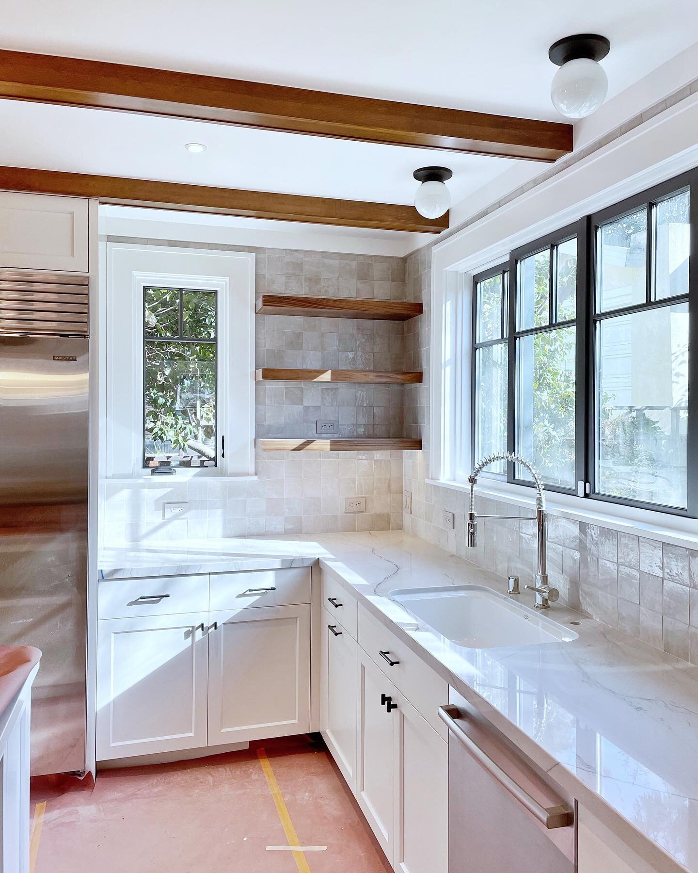In love with every single detail of the kitchen in our recent Rockridge Craftsman remodel: the handcrafted Moroccan zellige tile, the natural quartzite counters, the gleaming nickel culinary faucet, the rich wood box beams, and the custom divided lit