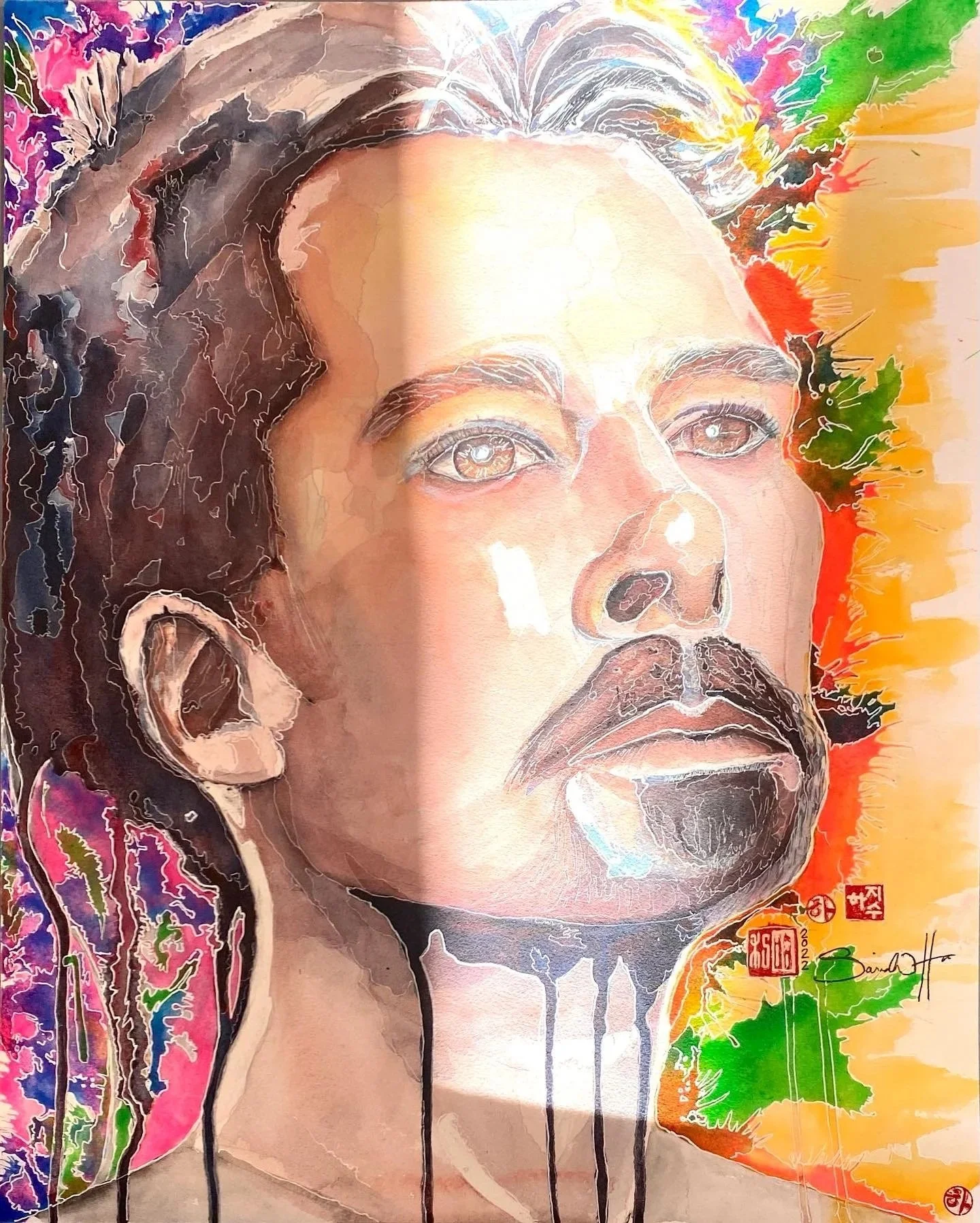 A colorful watercolor portrait of a man with dreadlocks, brown eyes, and a beard, set against a vibrant background with splashes of green, yellow, orange, red, purple, and black.