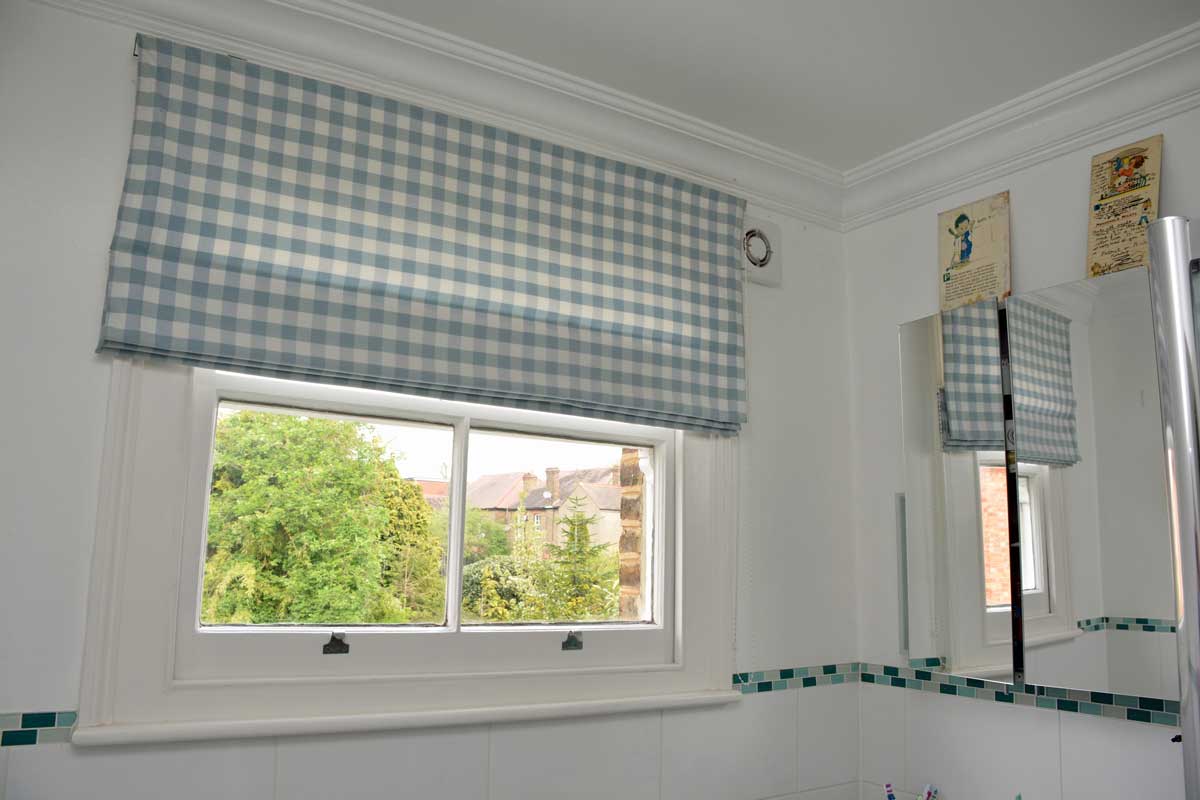 Roman blind with blue chequered fabric