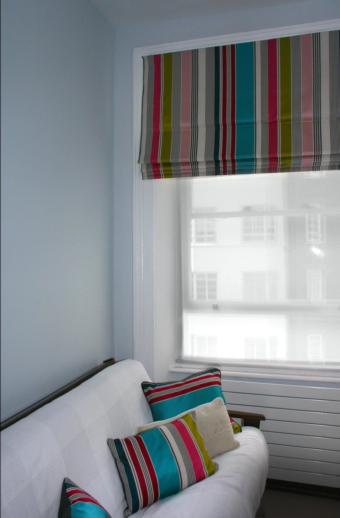 Roman blind with vertical striped multi-colour fabric