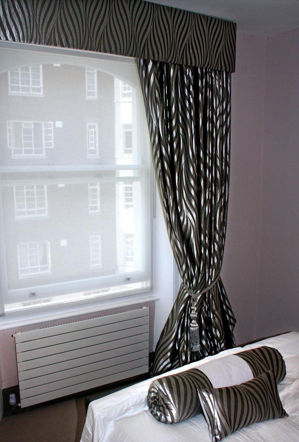 Full-length blackout blinds in a shiny, black and grey, zebra-print fabric