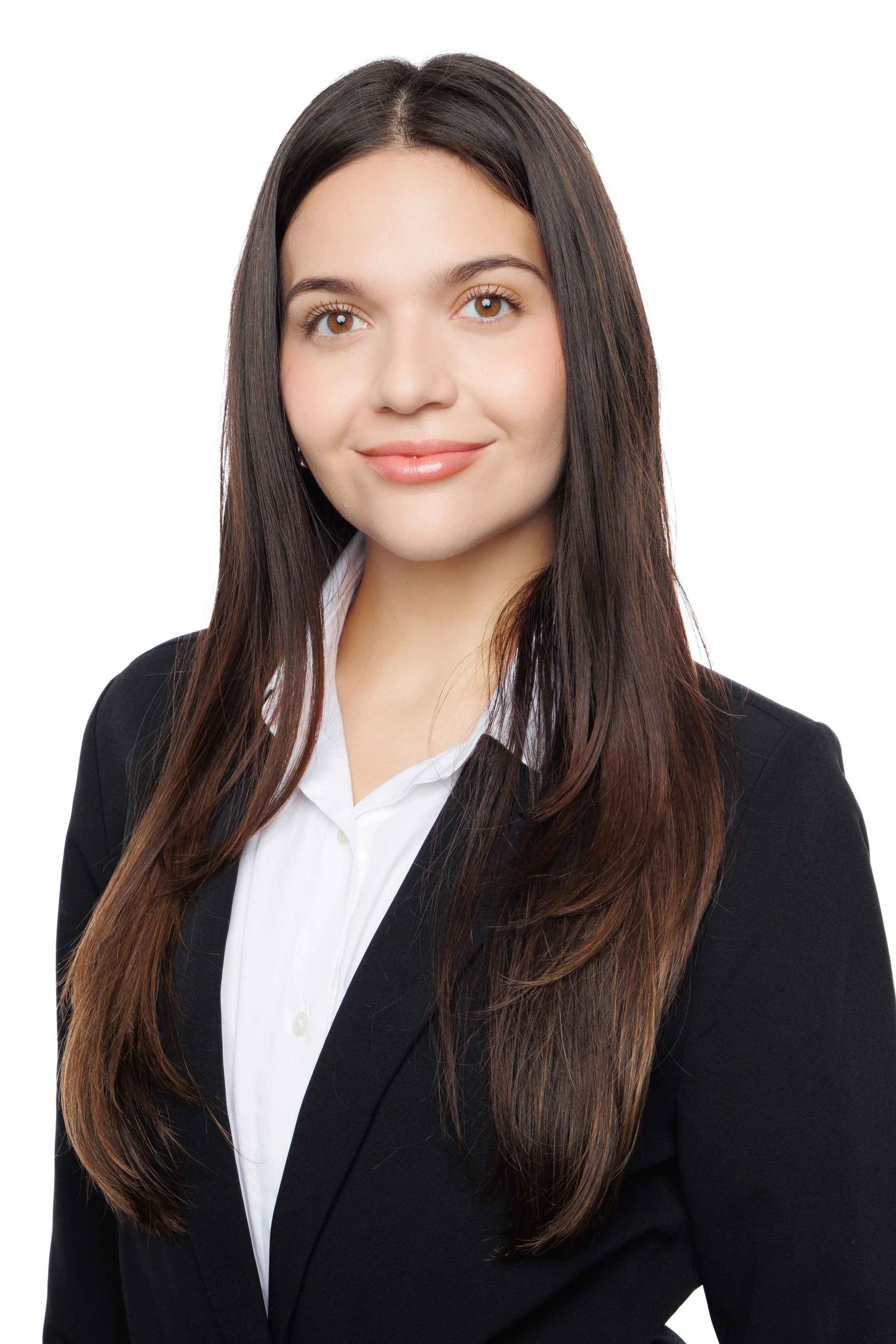 Professional headshot of a woman in a dark blazer and white collared shirt against a white background.