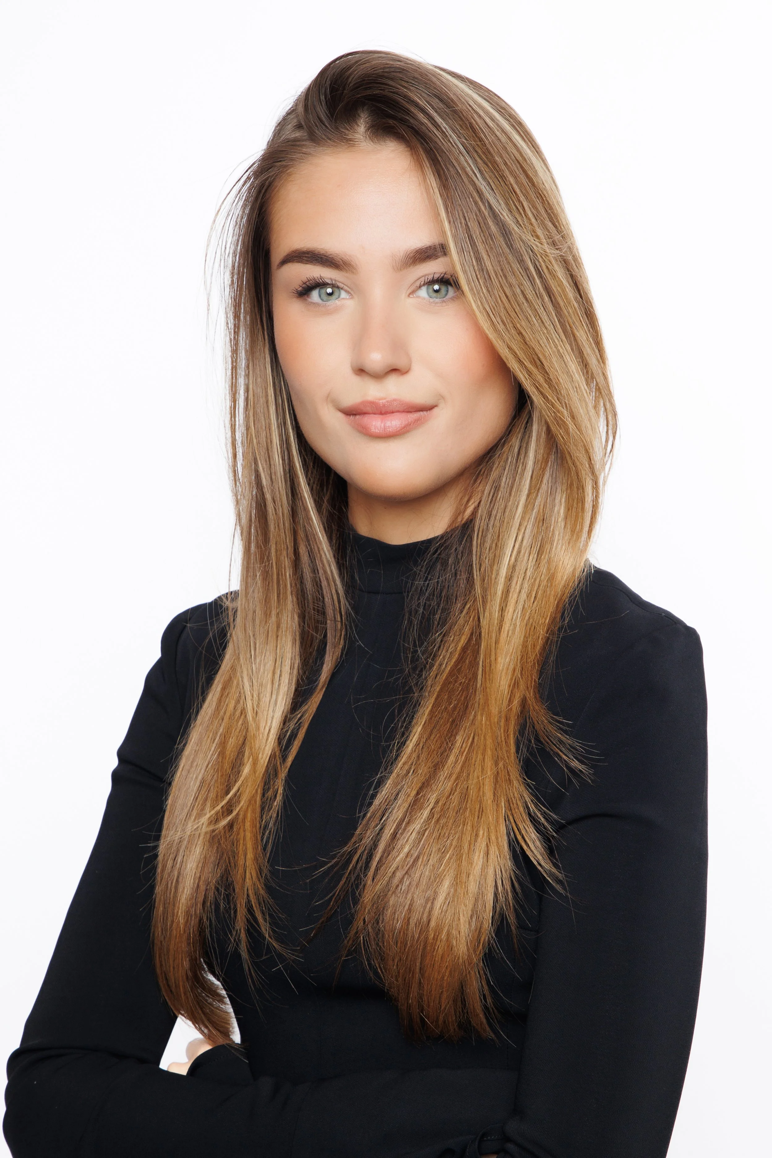 Professional studio headshot of a woman with long blonde hair wearing a black top against a white background.