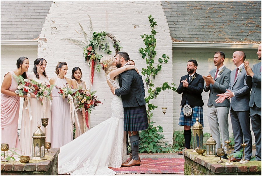  Bohemian bride and scottish groom kiss at their Leach Botanical Garden wedding ceremony. 