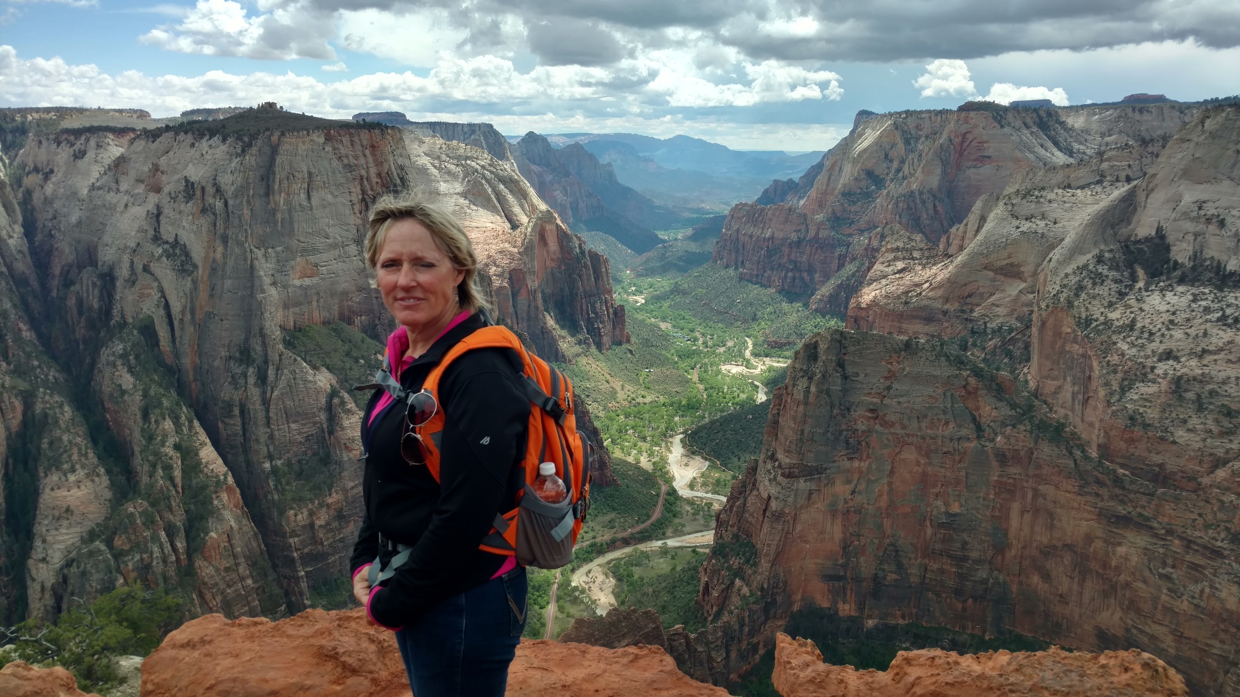 Linda, standing on the Point. Main Zion Canyon in background.