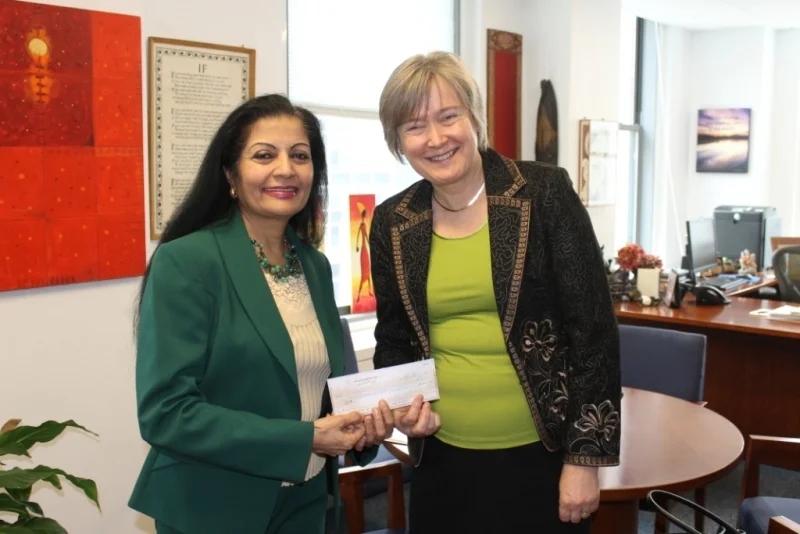 Deputy Executive Director Lakshmi Puri receives the check from Jaana Rehnstrom.