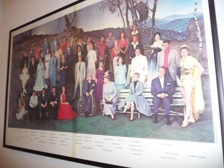 One day at MGM all actors and actresses who were present that day were called in for a group photo. Taina Elg second from the right in the back row wearing a red shirt.