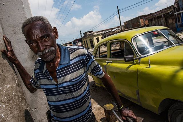 A car mechanic in Santiago de Cuba, working with virtually no tools or spare parts, trying to keep these cars running and on the road.