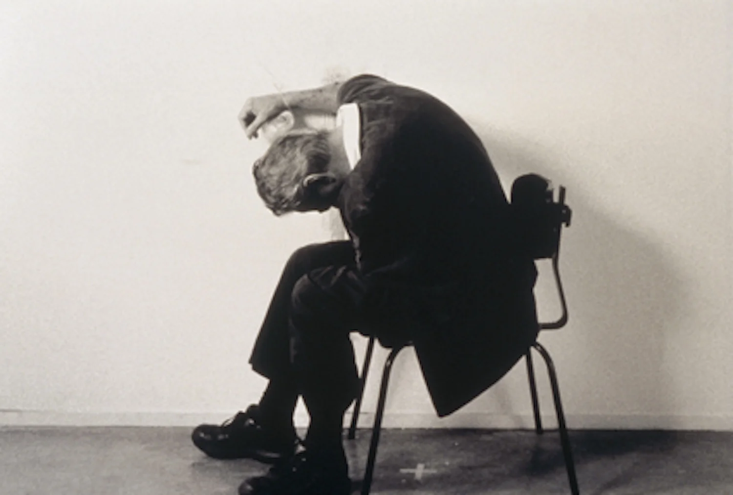 Mike Parr, Malevich (A Political Arm), performance for as long as possible.