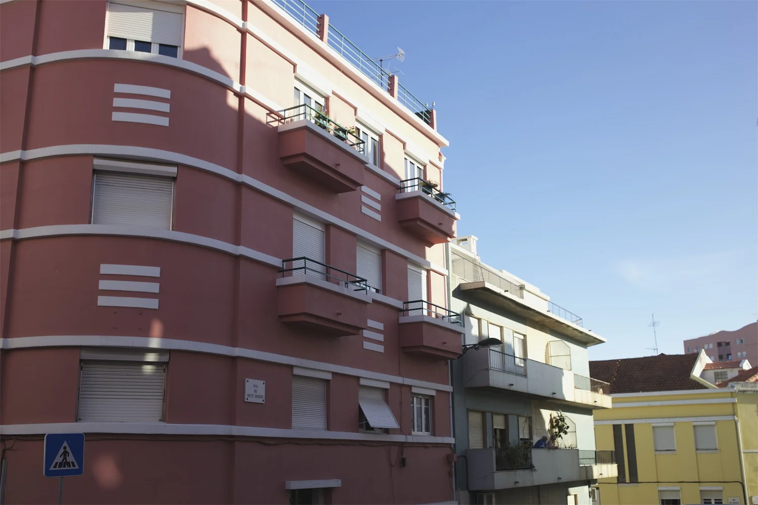 A view of buildings on by street by Poppy Danis, 2017