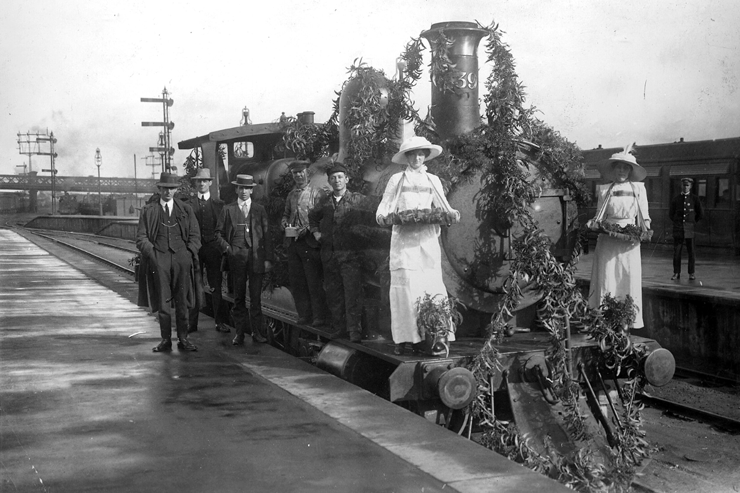  Wattle badge sellers with a locomotive decorated with wattle for Wattle Day, 1913. Image courtesy of the State Library of South Australia, PRG 280/1/7/249. 