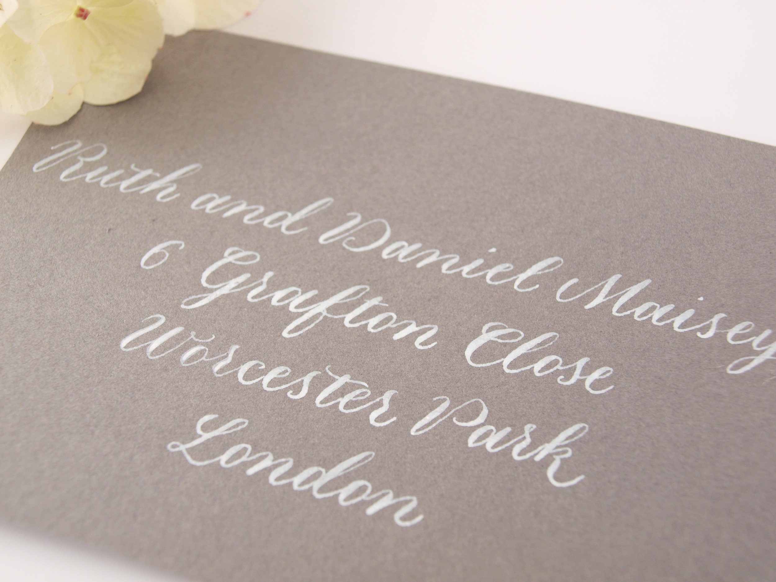 white copperplate calligraphy on grey envelope.jpg