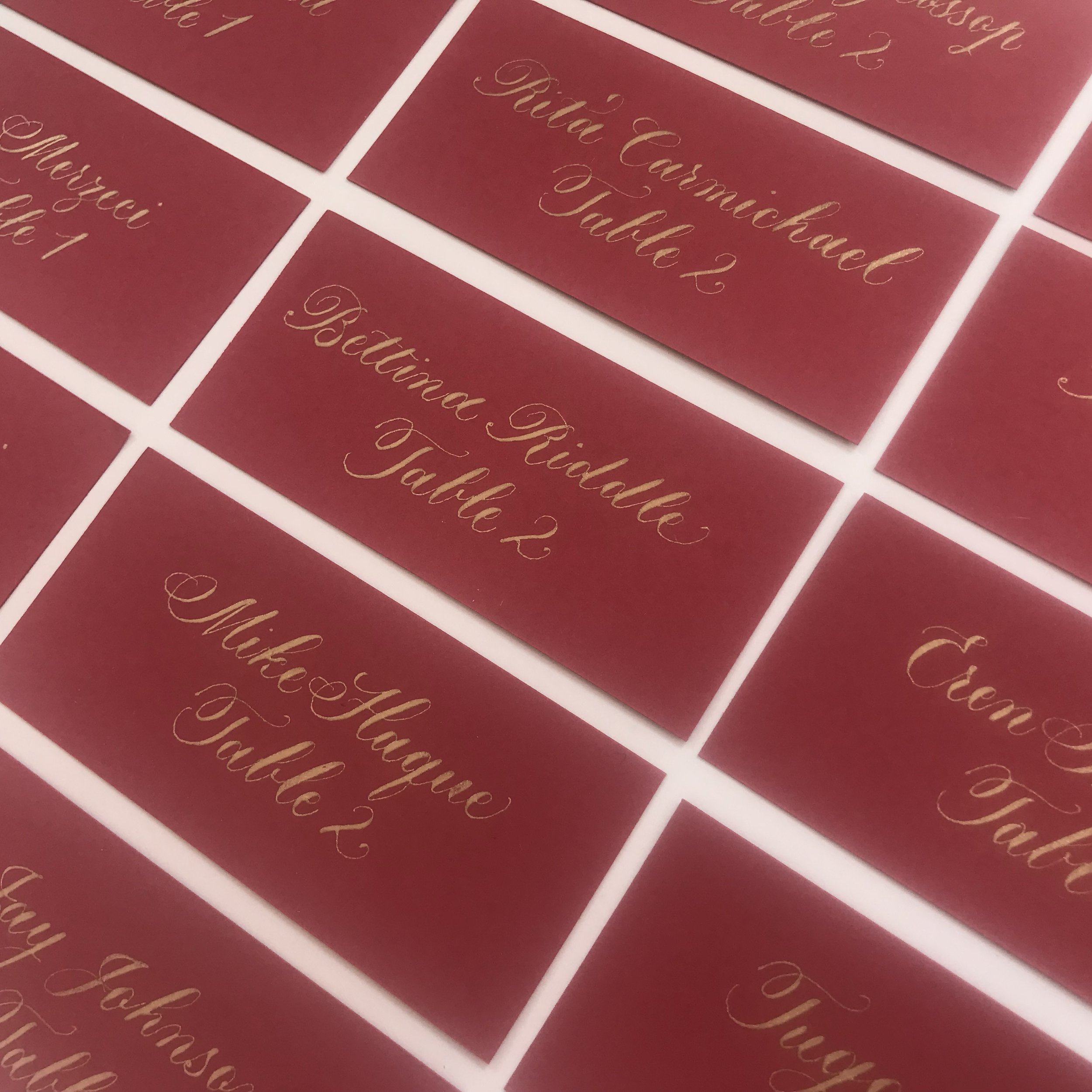 Calligraphy on red place cards.jpg