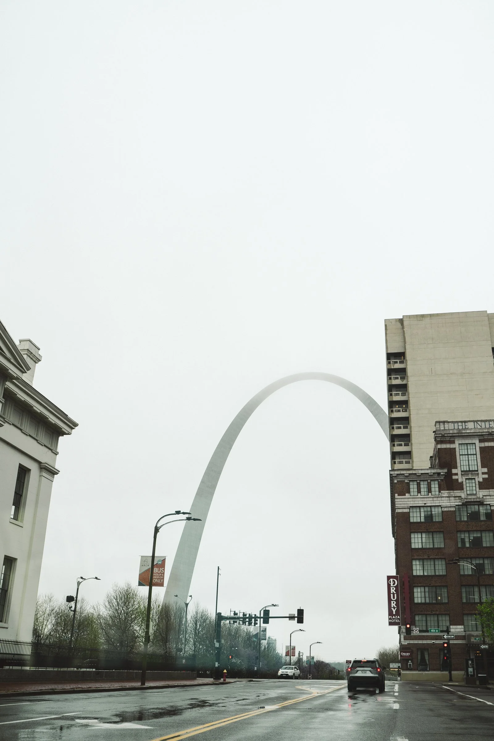 Overcast day in downtown St. Louis with the Gateway Arch visible in the background.