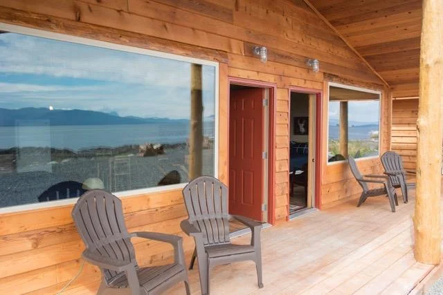 WINDOWS REFLECT THE AWESOME VIEWS FROM THE PORCH AT WHALE POINT CABINS, COFFMAN COVE. IMAGE: WHALE POINT CABINS.