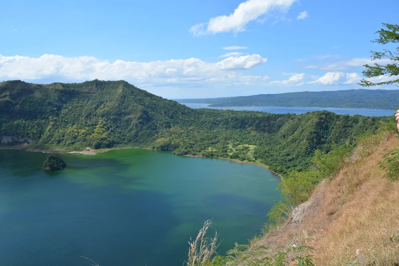 CRATER LAKE ON LUZON ISLAND IS THE WORLD'S SMALLEST VOLCANO CRATER LAKE, ONCE OVER FISHED, NOW THE ECONOMIC FOCUS IS ON RESPONSIBLE TOURISM © ARXEOLOG14⎮DREAMSTIME.COM