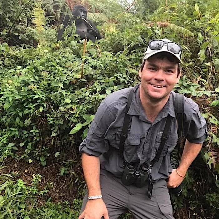 MARC CRONJE IN UGANDA, WITH A FRIEND LOOKING ON. IMAGE: THANKS TO MARC CRONJE