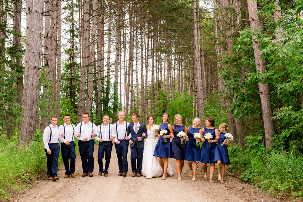 Wolf Lake, MN Country Styled Wedding, White Dress, Blue Suite | Photographed by Amber Langerud Photography | Bridal Party Walking