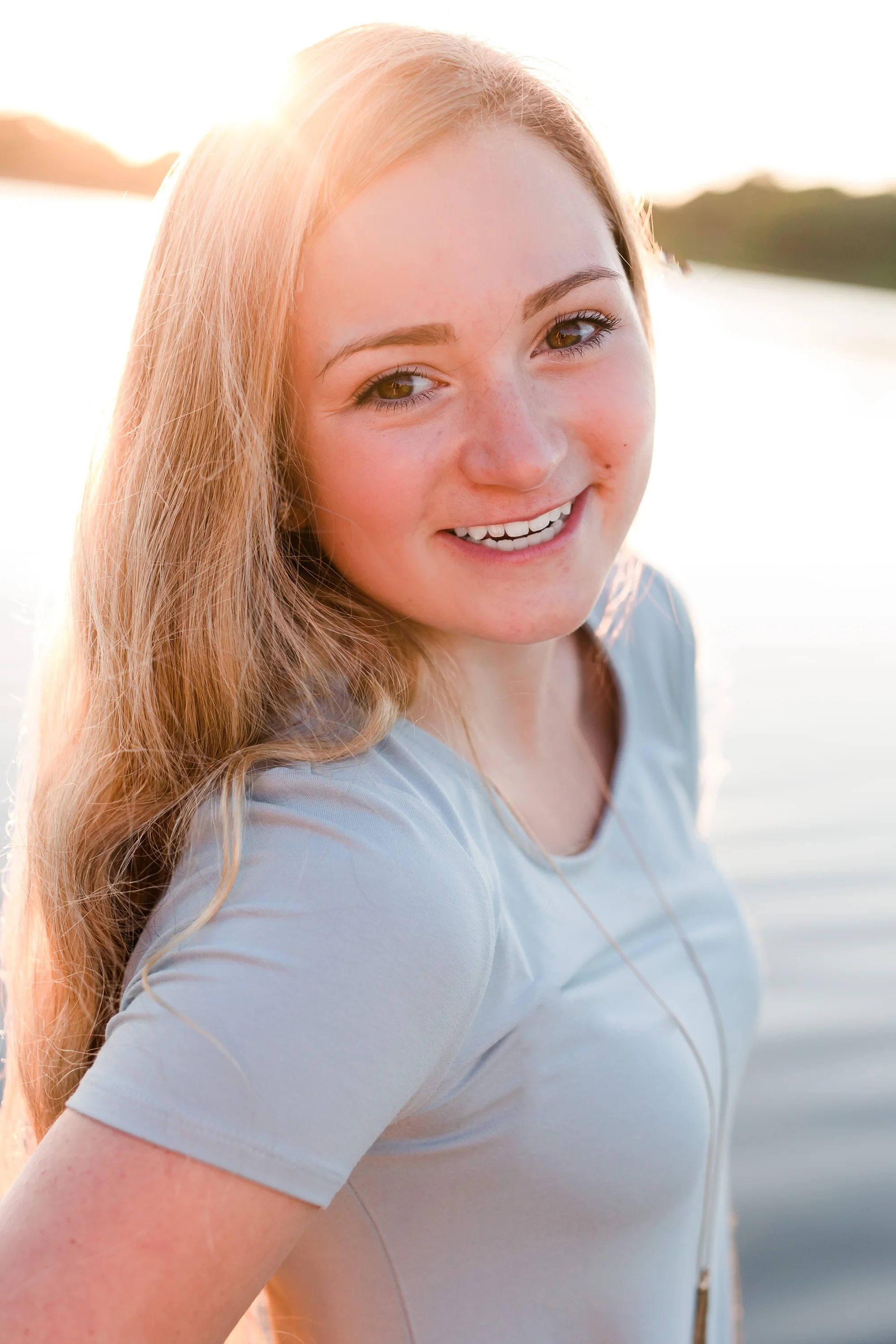 Country Styled High School Senior Pictures on a Farm and Little Cormorant Lake in Minnesota by Amber Langerud with a sunset on the lake