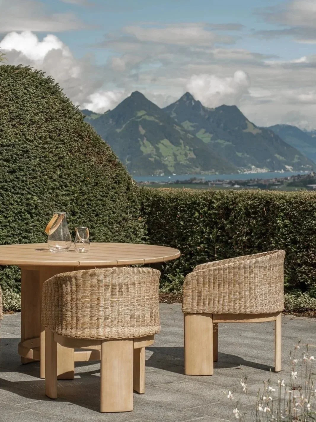 Outdoor dining terrace at Landhaus Ennetmoos with panoramic views of the surrounding mountains and Lake Lucerne.