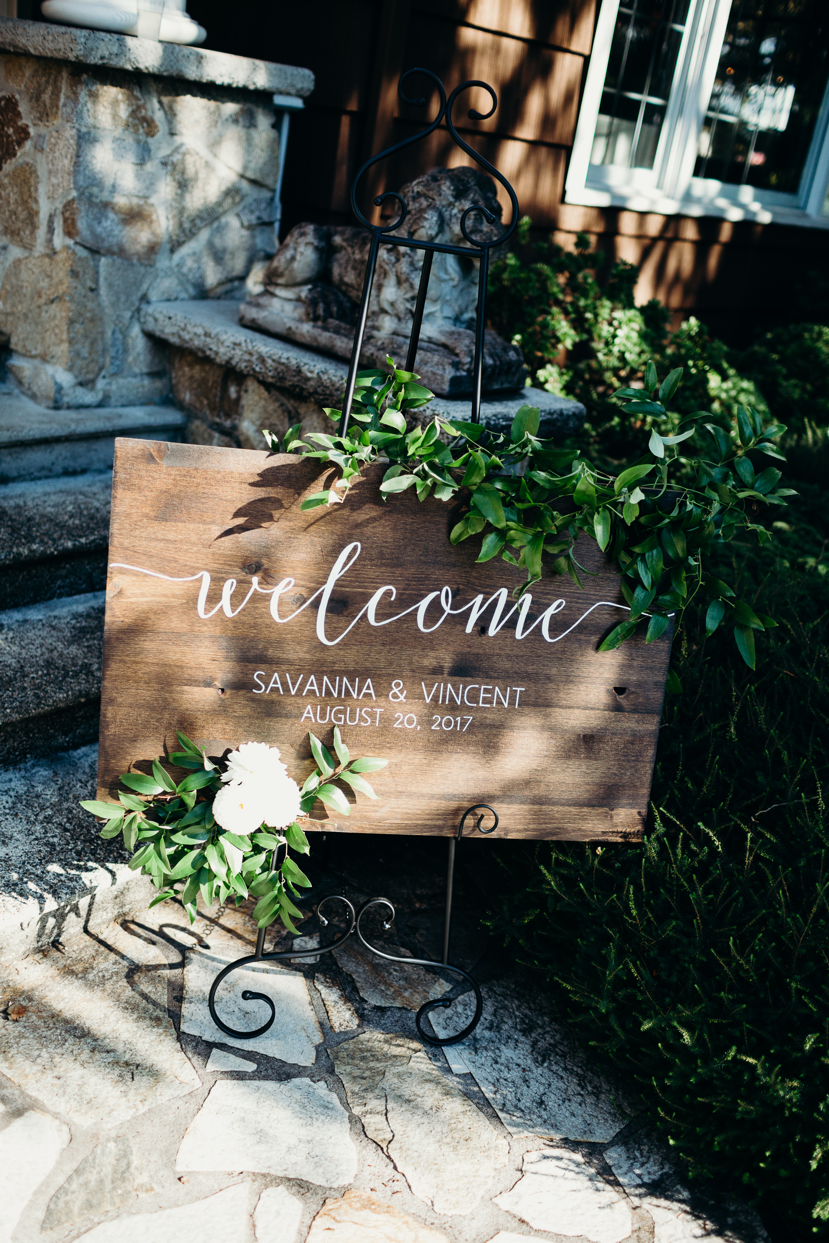 Wood Welcome Sign at Wedding with Greenery