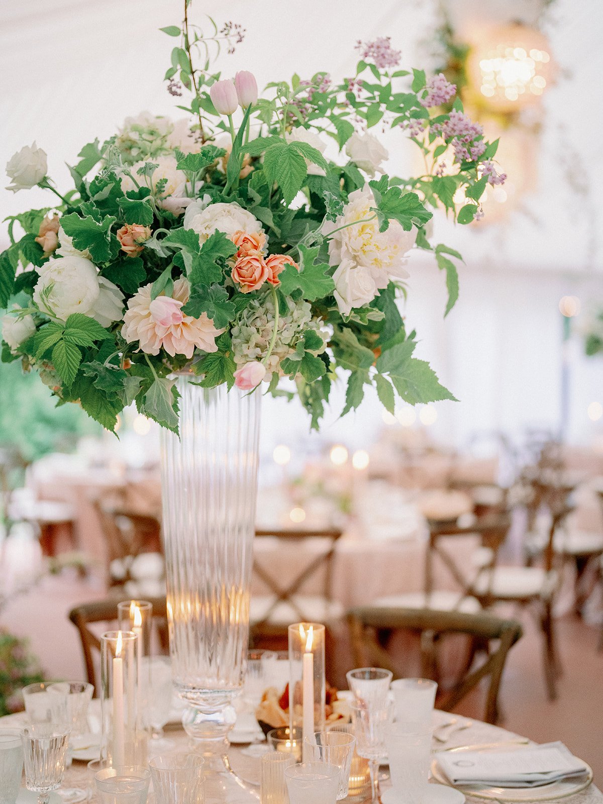 Tall elegant garden style wedding centerpiece with blush, ivory and greenery