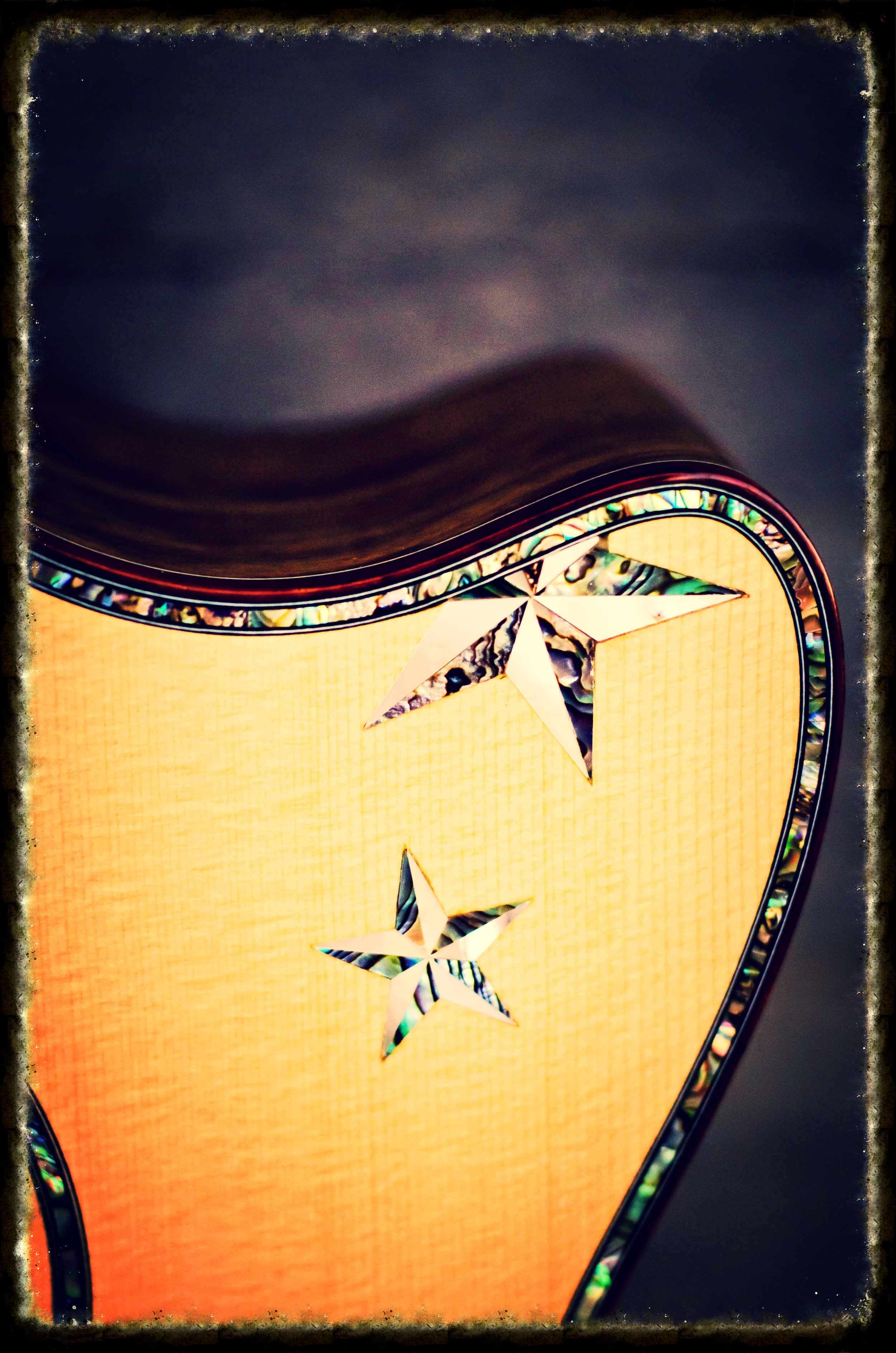  abalone stars inlaid on guitar top    