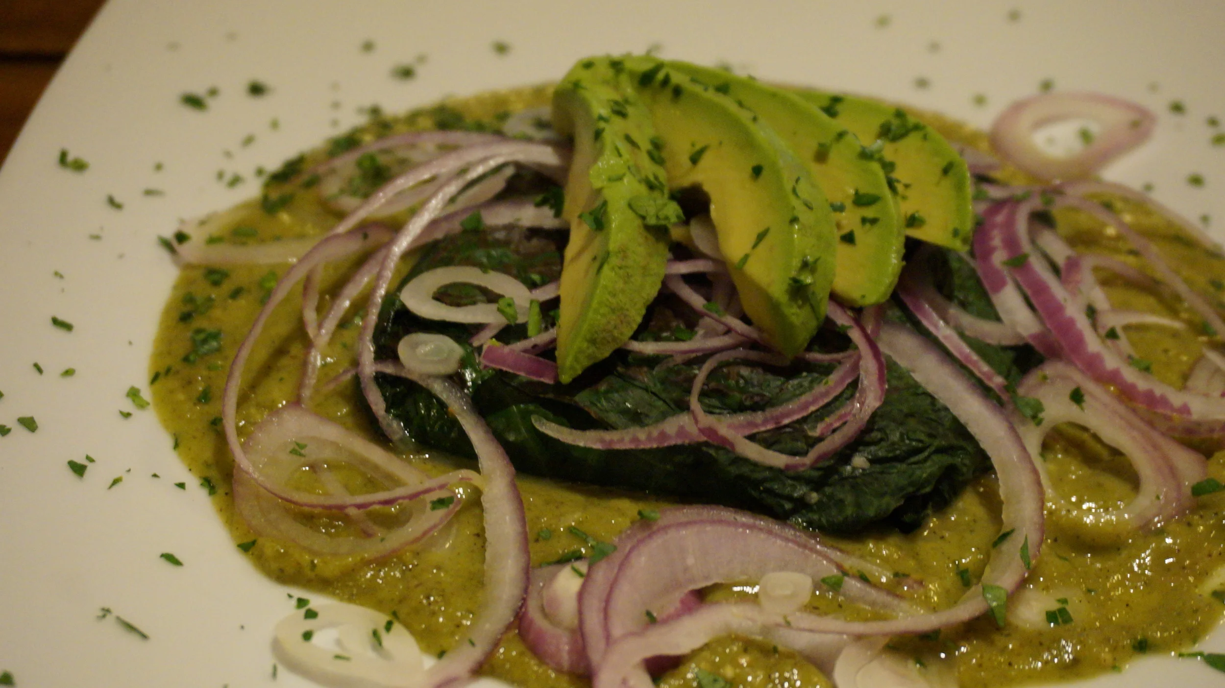  Local cheese baked in avocado leaves served in a green salsa. 