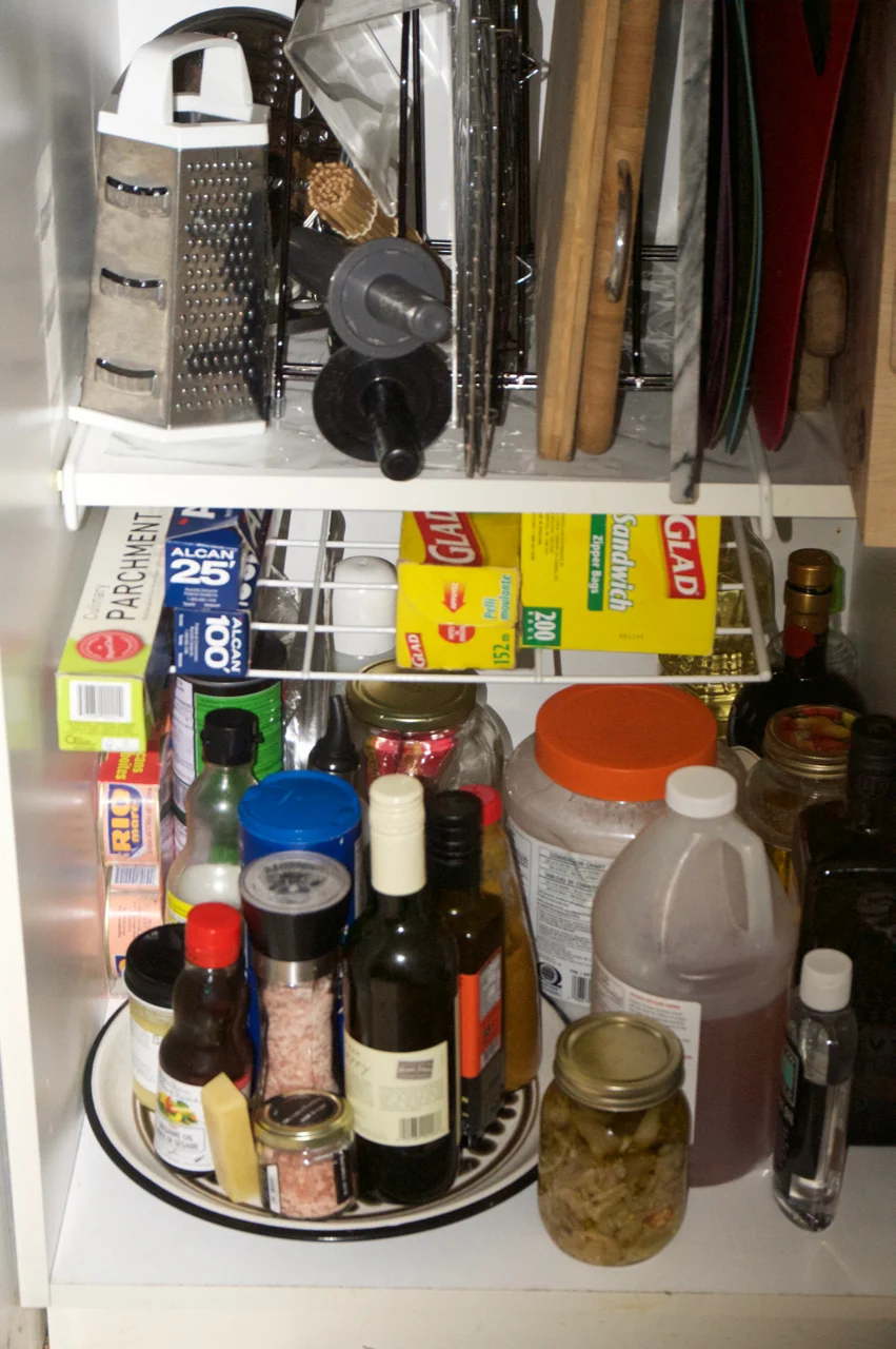 I bought this slide on shelf for my tin foil, parchment, etc a while ago but I thought I'd suggest it. I have frequently used condiments for cooking on a large plate I can just move up onto my counter when I need it!