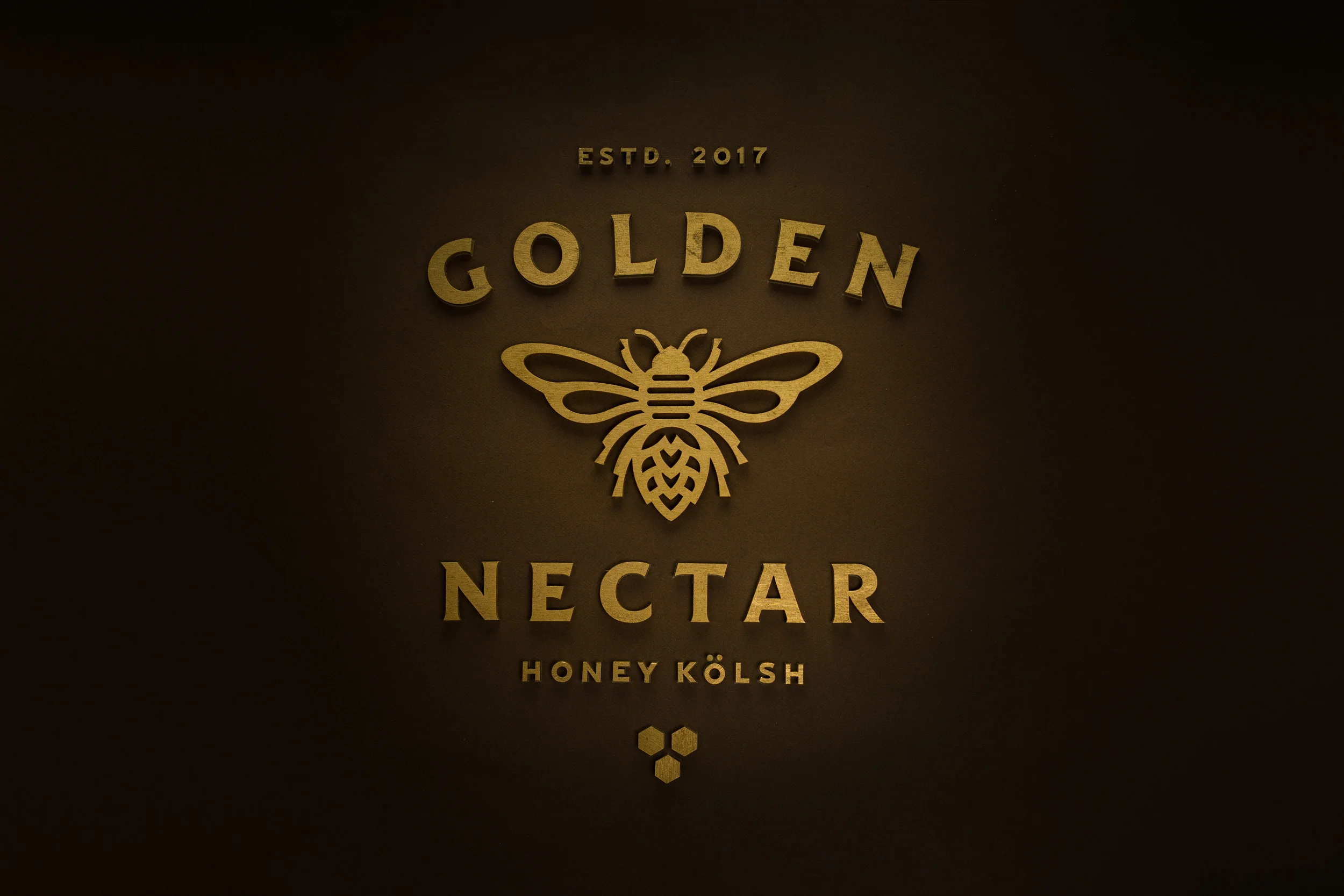 Golden Nectar is a micro brew based in the outskirts of Boston, MA. This micro brew is crafted loosely around a German-style Kolsch. A fermentation process such as this yields a light, vinous character, accompanied by a slightly dry, crisp finish; bright in color with malt characteristics. However, to pack a flavorful punch, honey from local New England distributors was added to the end of the boil to increase the alcohol volume to 6%. To compliment the honey a hint of jasmine tea was included to the secondary fermentation resulting in a brand that reflects a crisp, light, and drinkable Kolsch style beer. Best served with company on those warm summer days. 