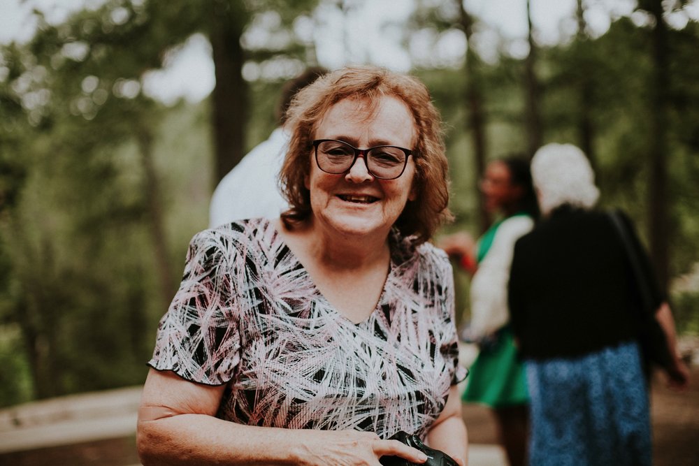  The dress theme for the whole wedding celebration was rainbows - their guests dressed in one color head to toe as part of the theme. The wedding reception at the ranch was near the orchard by the acequia, and was lit by candles and solar lights prim