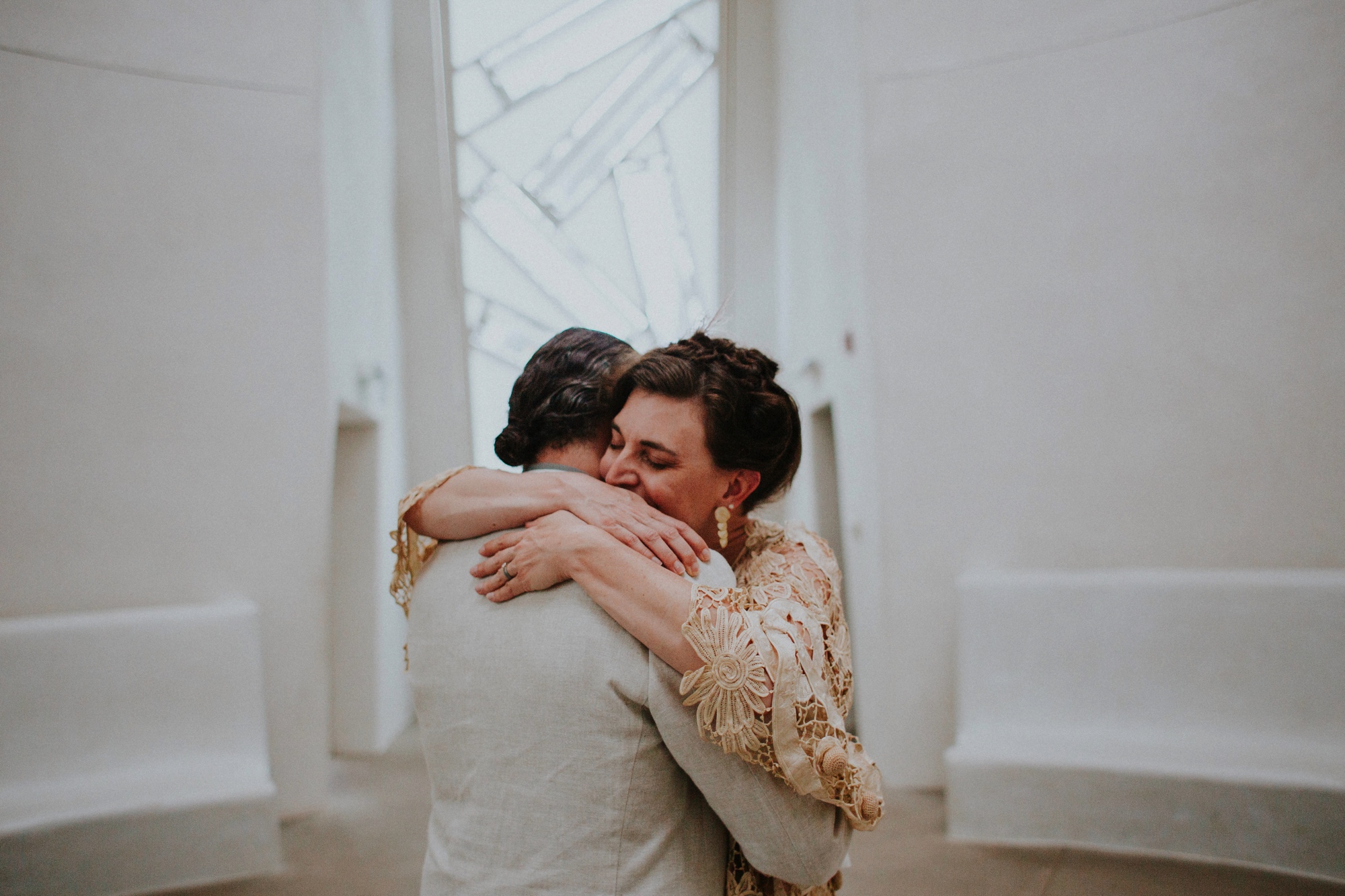  The dress theme for the whole wedding celebration was rainbows - their guests dressed in one color head to toe as part of the theme. The wedding reception at the ranch was near the orchard by the acequia, and was lit by candles and solar lights prim