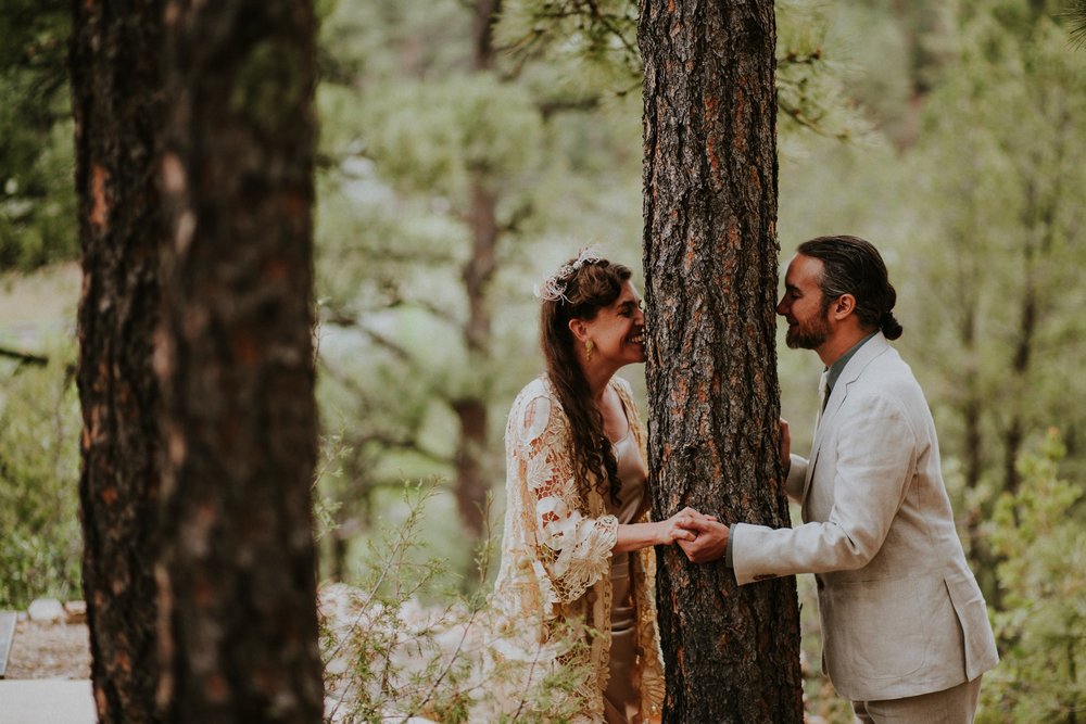  The dress theme for the whole wedding celebration was rainbows - their guests dressed in one color head to toe as part of the theme. The wedding reception at the ranch was near the orchard by the acequia, and was lit by candles and solar lights prim