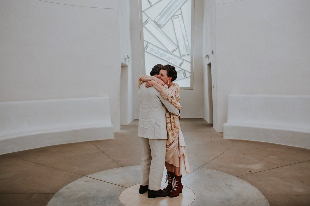  The dress theme for the whole wedding celebration was rainbows - their guests dressed in one color head to toe as part of the theme. The wedding reception at the ranch was near the orchard by the acequia, and was lit by candles and solar lights prim