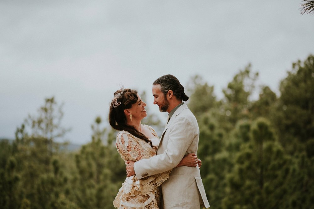  The dress theme for the whole wedding celebration was rainbows - their guests dressed in one color head to toe as part of the theme. The wedding reception at the ranch was near the orchard by the acequia, and was lit by candles and solar lights prim