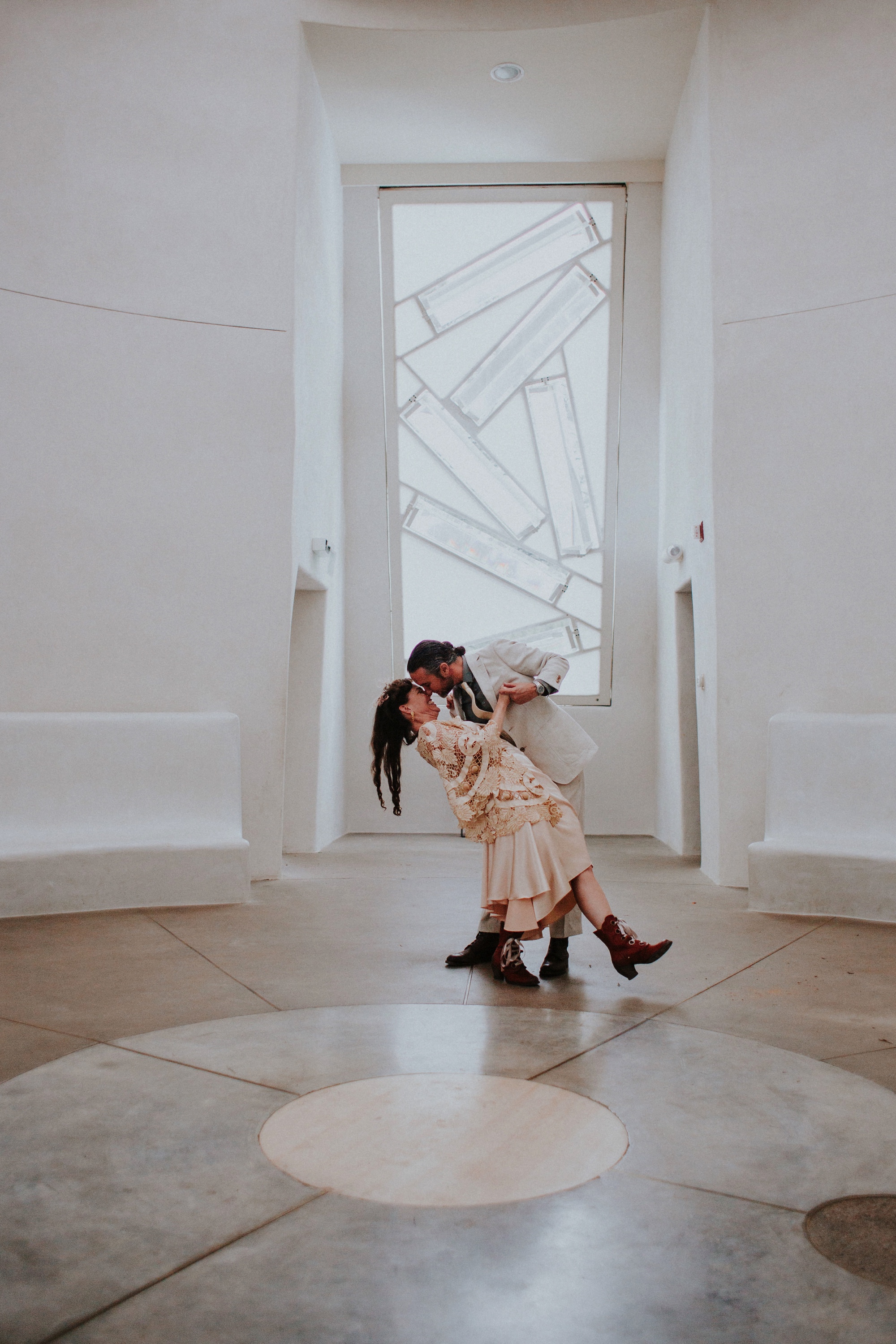  The dress theme for the whole wedding celebration was rainbows - their guests dressed in one color head to toe as part of the theme. The wedding reception at the ranch was near the orchard by the acequia, and was lit by candles and solar lights prim