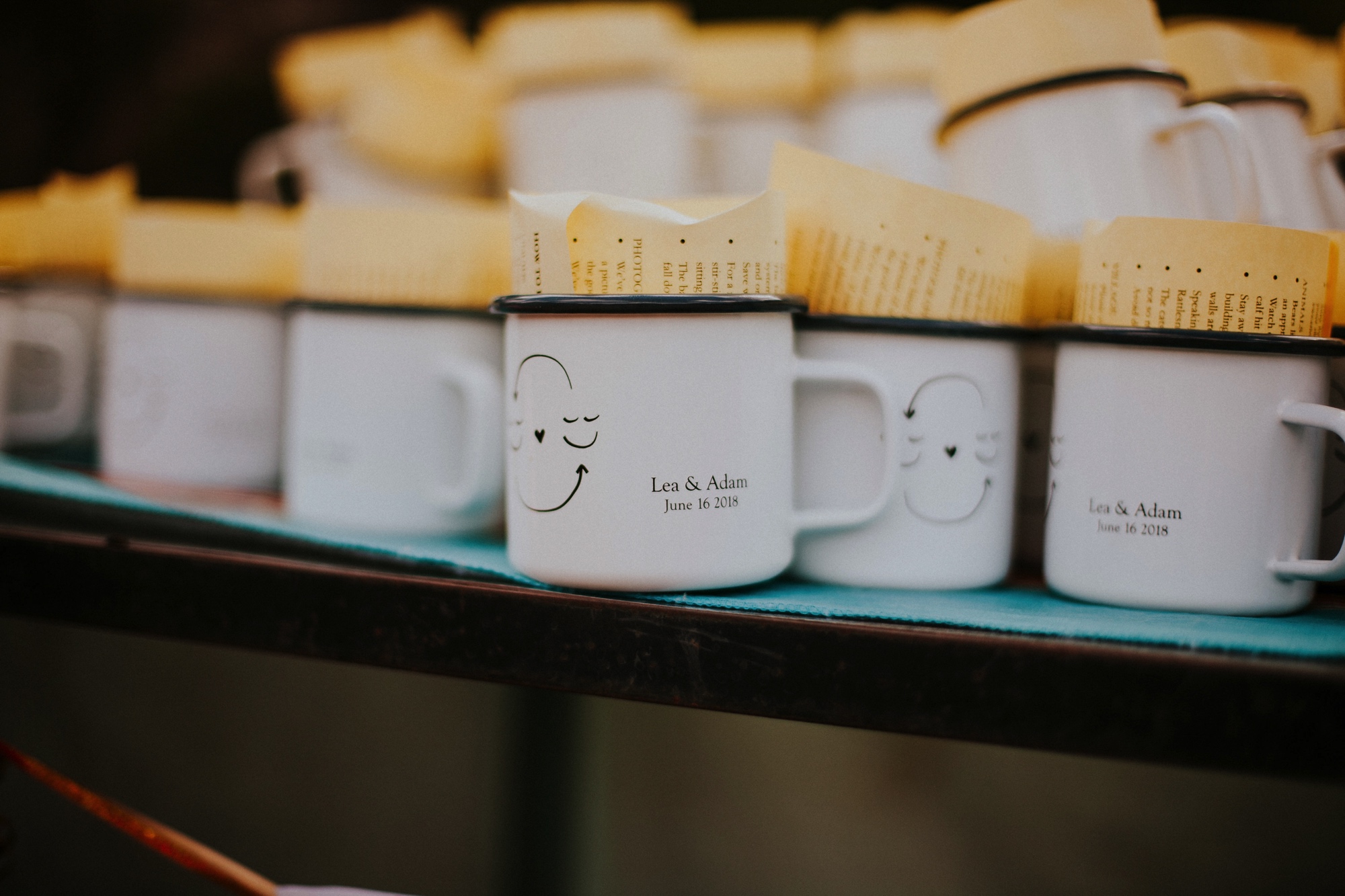  They arrived by rainbow procession from the river to their gorgeous wedding reception. They made cups for everyone with an image from a note one of them left for the other early in their relationship that has become a note that they leave often for 