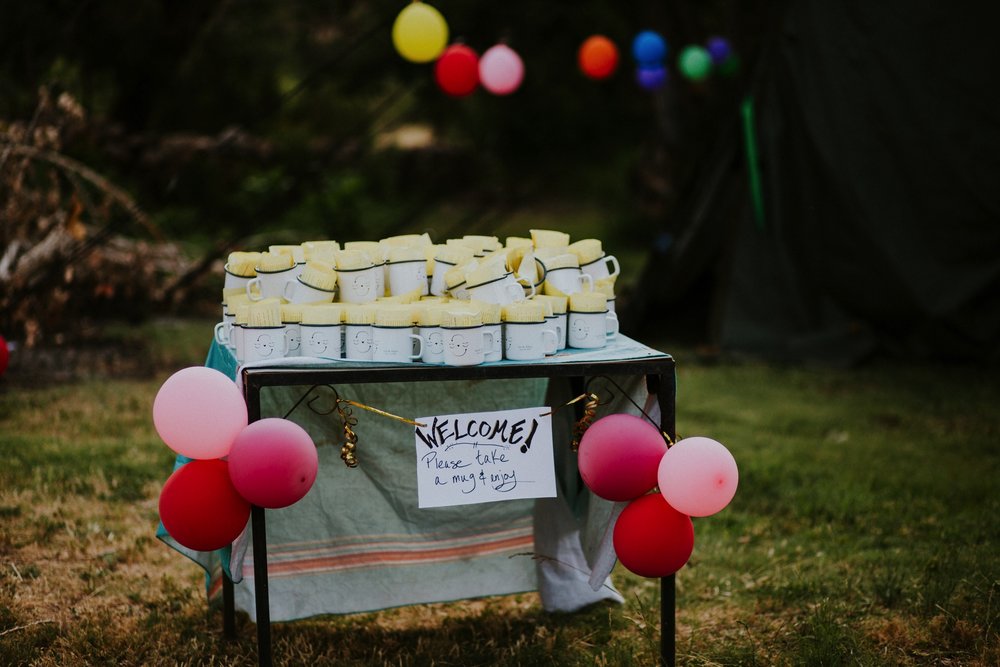  They arrived by rainbow procession from the river to their gorgeous wedding reception. They made cups for everyone with an image from a note one of them left for the other early in their relationship that has become a note that they leave often for 