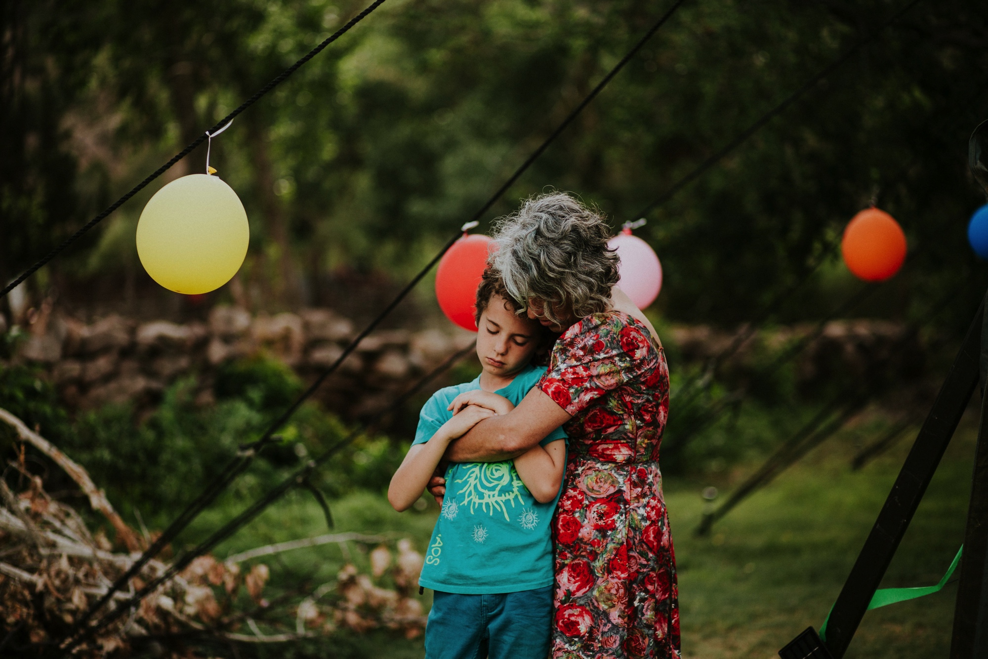  The dress theme for the whole wedding celebration was rainbows - their guests dressed in one color head to toe as part of the theme. The wedding reception at the ranch was near the orchard by the acequia, and was lit by candles and solar lights prim