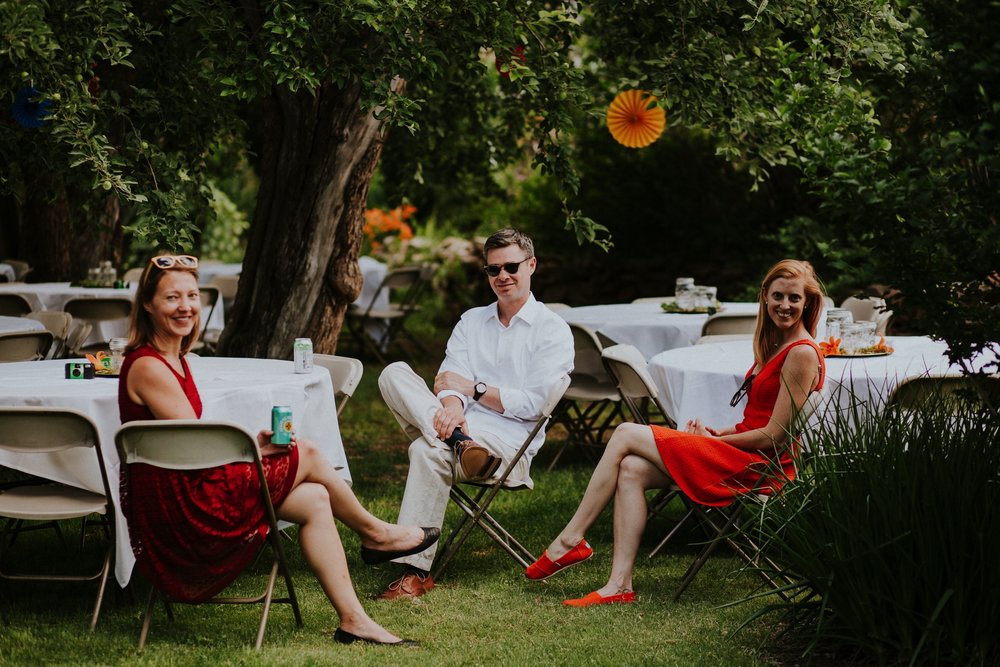  The dress theme for the whole wedding celebration was rainbows - their guests dressed in one color head to toe as part of the theme. The wedding reception at the ranch was near the orchard by the acequia, and was lit by candles and solar lights prim