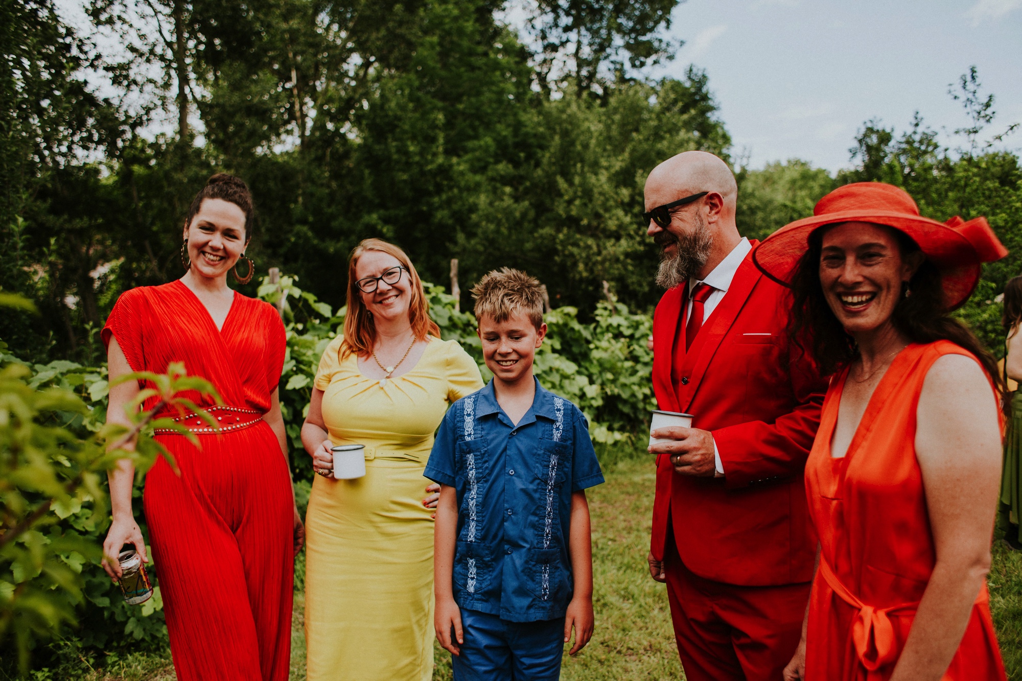  The dress theme for the whole wedding celebration was rainbows - their guests dressed in one color head to toe as part of the theme. The wedding reception at the ranch was near the orchard by the acequia, and was lit by candles and solar lights prim