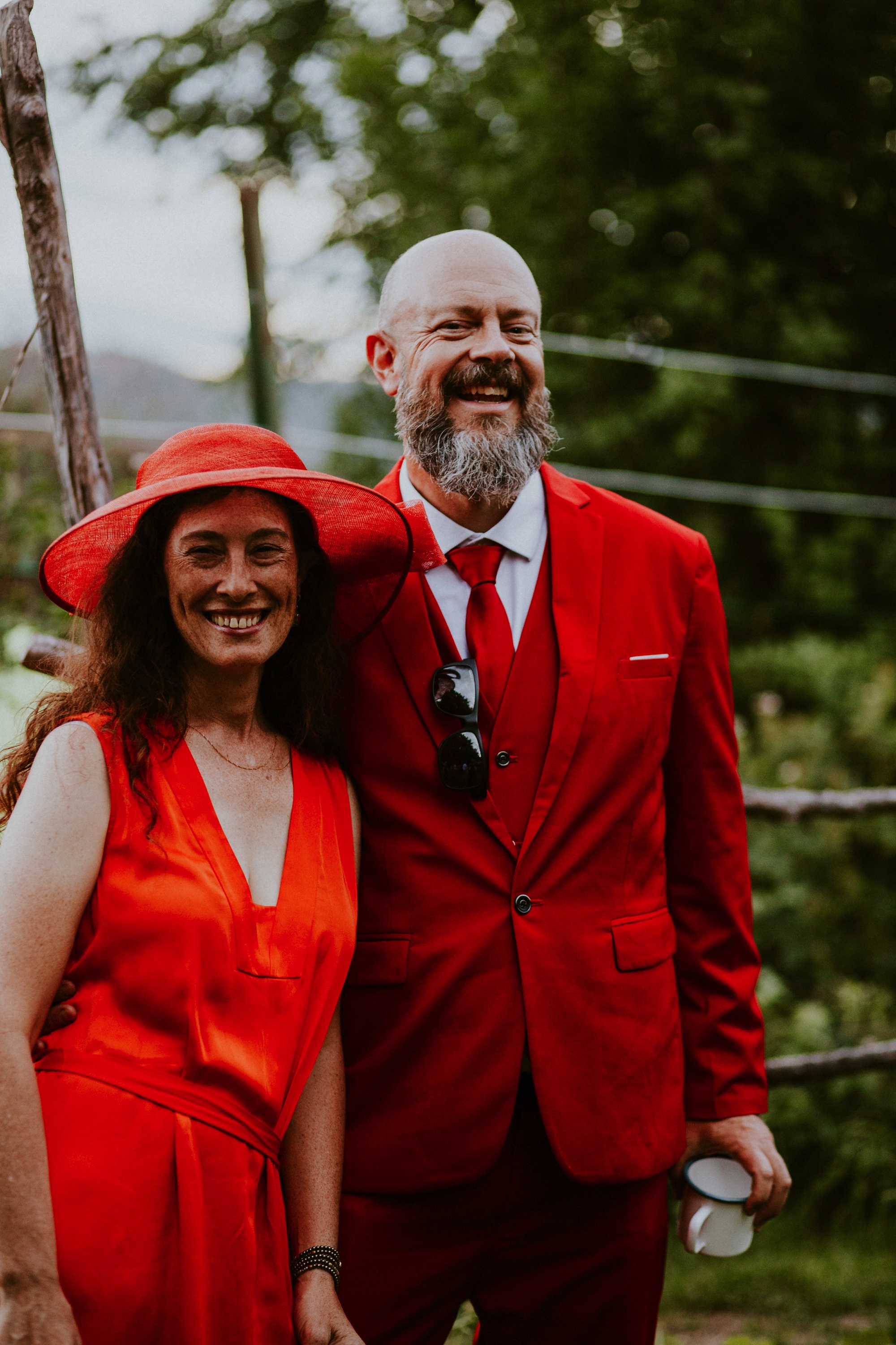  The dress theme for the whole wedding celebration was rainbows - their guests dressed in one color head to toe as part of the theme. The wedding reception at the ranch was near the orchard by the acequia, and was lit by candles and solar lights prim