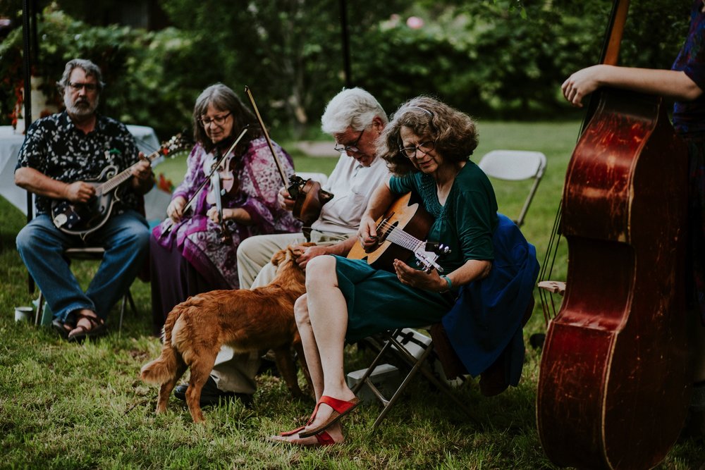  The dress theme for the whole wedding celebration was rainbows - their guests dressed in one color head to toe as part of the theme. The wedding reception at the ranch was near the orchard by the acequia, and was lit by candles and solar lights prim